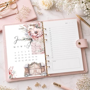 May include: A pink leather ring-bound planner open to a January calendar page. The page features floral illustrations, a wooden gate graphic, and a daily schedule with hourly slots from 7:00 to 8:00 and a notes section. The planner is surrounded by gold scissors, a gold pen, and white flowers.