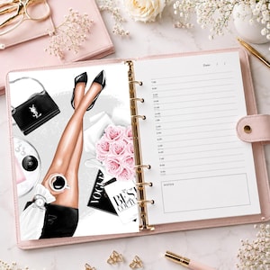 May include: A pink ring-bound planner featuring an illustration of crossed legs in black heels, a black handbag, a bouquet of pink roses, a coffee cup, and a magazine with the text The Best Couture. The planner page includes hourly lines.