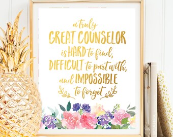 May include: A gold framed print with a white background and gold lettering that reads "a truly GREAT COUNSELOR is HARD to find, DIFFICULT to part with, and IMPOSSIBLE to forget". The print is decorated with a watercolor floral design in shades of pink, purple, and blue.
