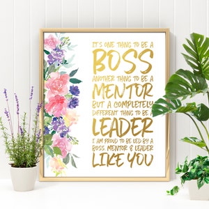 May include: A gold foil print with a floral design on a white background. The text reads "It's one thing to be a boss, another thing to be a mentor, but a completely different thing to be a leader. I am proud to be led by a boss, mentor & leader like you."