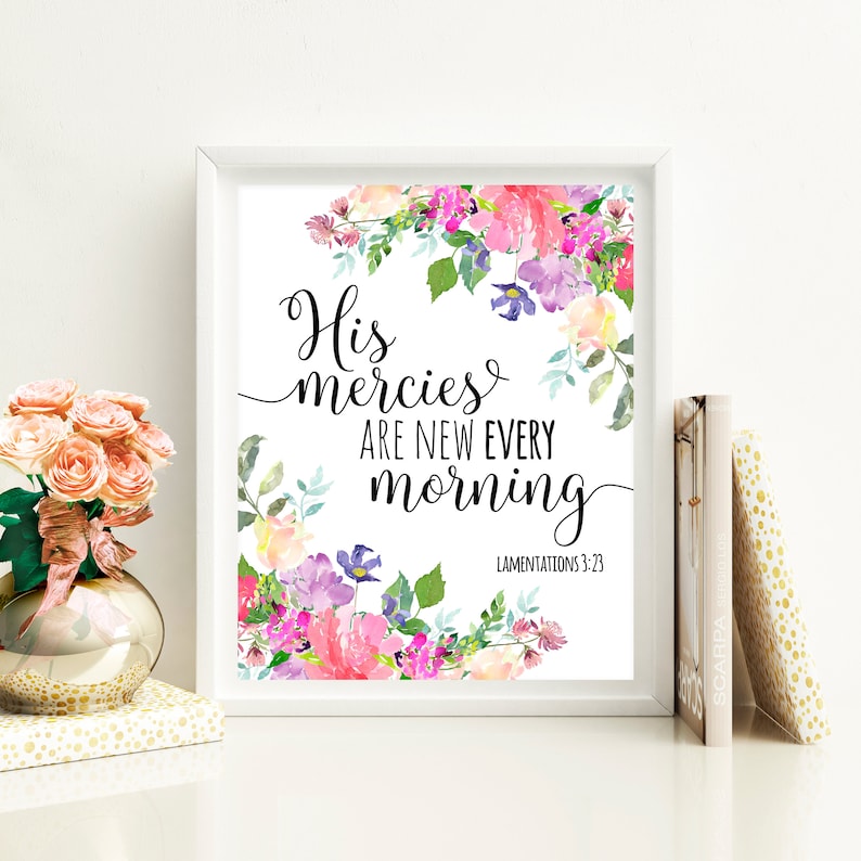 May include: A white framed print with a watercolor floral design. The text reads "His mercies are new every morning" with the scripture reference "Lamentations 3:23".