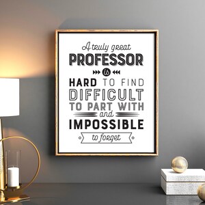 May include: A black and white typography print with a gold frame. The print reads "A truly great PROFESSOR is HARD TO FIND DIFFICULT TO PART WITH and IMPOSSIBLE to forget."