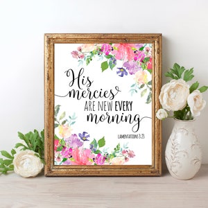 May include: A framed print with a watercolor floral design. The text reads "His mercies are new every morning" with the scripture reference "Lamentations 3:23".