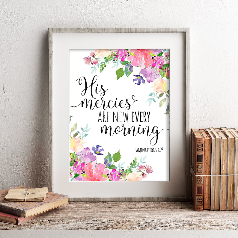 May include: A framed print with a watercolor floral wreath surrounding the text "His mercies are new every morning" with the scripture reference "Lamentations 3:23".