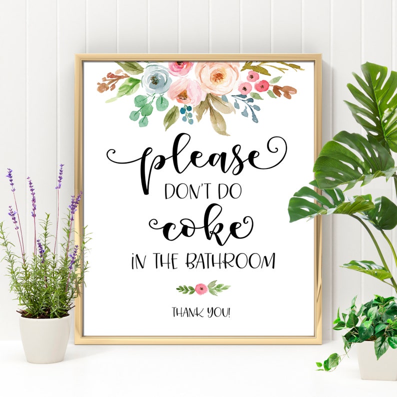 May include: A white sign with a gold frame and floral design at the top. The sign says "Please don't do coke in the bathroom. Thank you!"