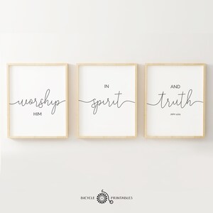 May include: Three framed prints with black calligraphy on a white background. The prints read "worship him", "in spirit", and "and truth John 4:24".