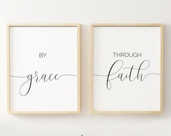 May include: Two framed prints with black calligraphy on a white background. The left print says "By grace" and the right print says "Through faith".