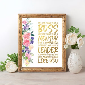 May include: A gold foil print with a floral design on a white background. The text reads "It's one thing to be a boss, another thing to be a mentor, but a completely different thing to be a leader. I am proud to be led by a boss, mentor & leader like you."
