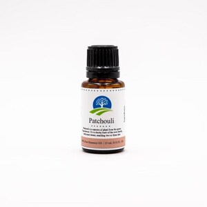 May include: A brown glass bottle of Patchouli essential oil with a black cap. The label is white with blue and green accents and reads "Patchouli 100% Pure Essential Oil | 15 ml / 0.51 fl. oz."