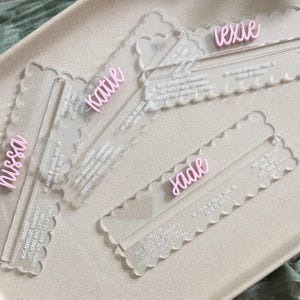 May include: Three clear acrylic rulers with scalloped edges, each featuring a personalized name in raised pink script lettering. The rulers are engraved with instructional text including Charleston, Right-Across-Left, and Left-Across-Right.