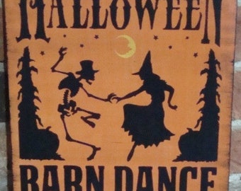 May include: A vintage-style Halloween sign with an orange background and black text. It reads "Halloween Barn Dance October 31st". The sign features a skeleton and a witch dancing.