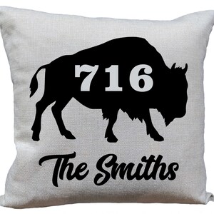 May include: A white pillow with a black silhouette of a buffalo with the number 716 on its side. The text "The Smiths" is printed below the buffalo.