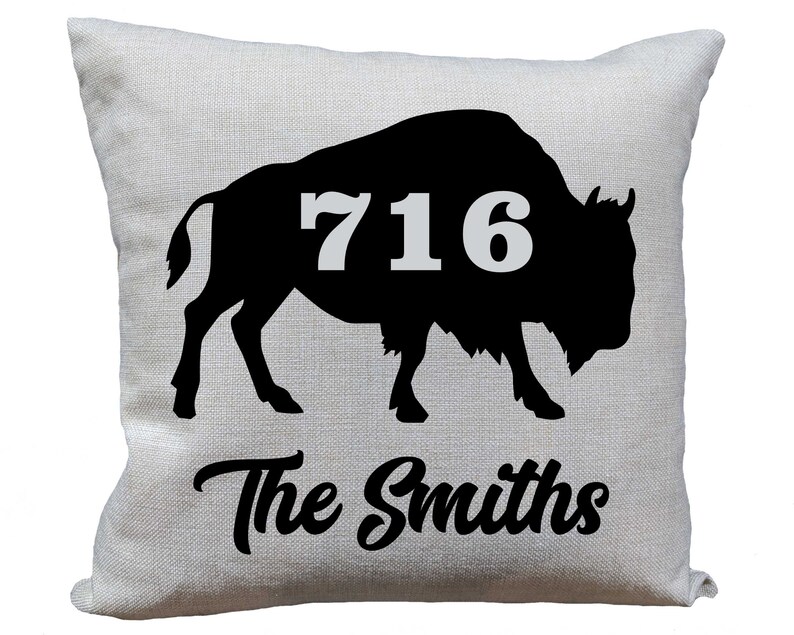 May include: A white pillow with a black silhouette of a buffalo with the number 716 on its side. The text "The Smiths" is printed below the buffalo.