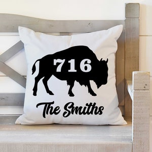 May include: White throw pillow with a black silhouette of a buffalo and the number 716. The text "The Smiths" is printed below the buffalo.