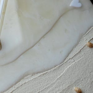 Beige ocean-themed clock with acrylic hands and a soothing seaside design