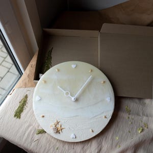Nautical resin wall clock with agate geode and coastal charm for bedroom decor.