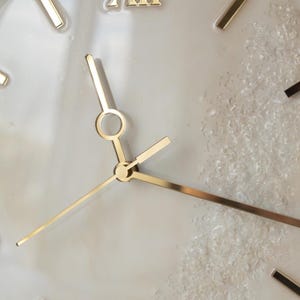 Close-up of the clock, focusing on the Roman numerals and the fine gold details of the clock face.