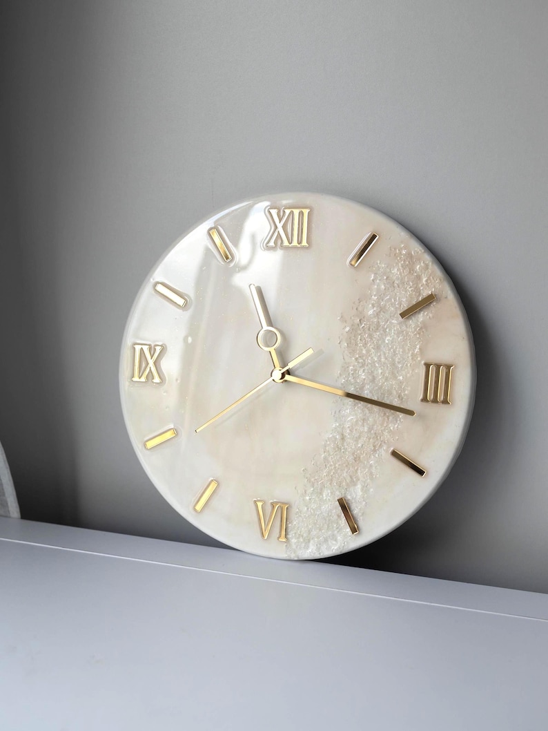 View of the marble resin wall clock on a minimalist grey wall, emphasizing its luxurious design.