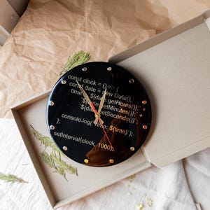 A modern resin clock for tech lovers, featuring JavaScript-inspired design and a polished finish