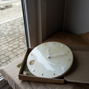 Unique resin wall clock featuring natural coastal materials and minimalist details.