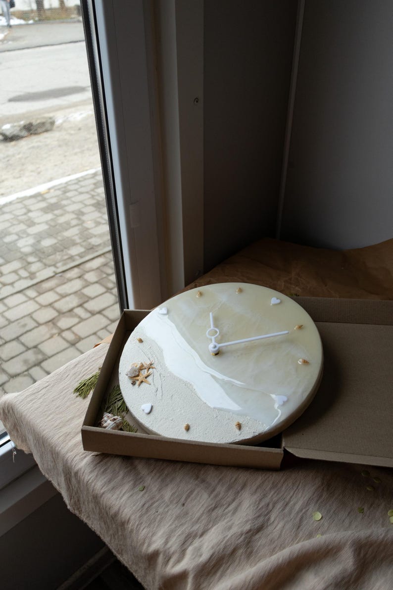 Unique resin wall clock featuring natural coastal materials and minimalist details.