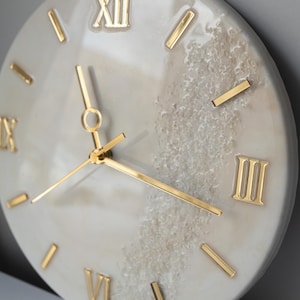 A top view of the clock on a neutral background, showing its large Roman numeral markers.