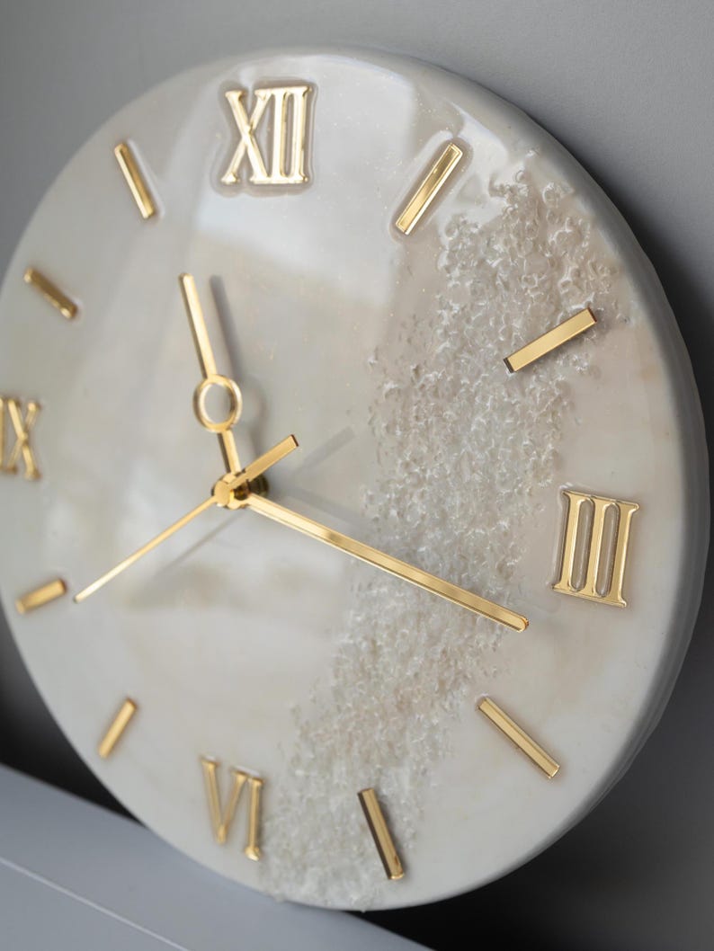 A top view of the clock on a neutral background, showing its large Roman numeral markers.