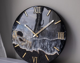 May include: Black and white resin clock with gold Roman numeral markings and gold hands. The clock face has a wave design.