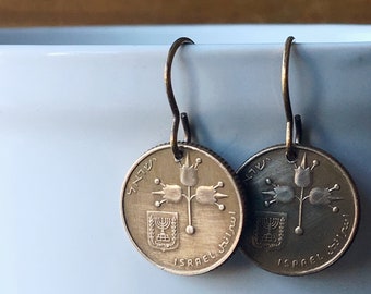 May include: A pair of earrings made from Israeli 10 Agorot coins featuring a stylised flower design and the text "ISRAEL" in Hebrew and English.