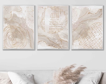 Peut inclure: Ensemble de trois impressions d'art abstraites encadrées. Chaque impression présente une palette neutre avec des accents beiges, blancs et dorés. Les motifs comprennent des motifs tourbillonnants, des formes géométriques et des éclats d'or, pour une esthétique moderne.