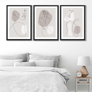 May include: Three minimalist line art prints in black frames on a white wall. Each print features a single line drawing of a woman's face or body with abstract shapes in shades of grey.