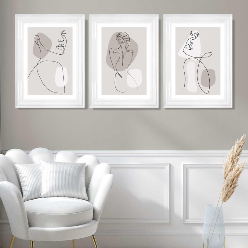 May include: Three framed prints featuring minimalist line drawings of figures in a neutral colour palette. The figures are depicted in various poses, with a focus on the lines and shapes of the body.