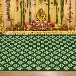 May include: A rectangular floor mat featuring a deep green background with a repeating white geometric pattern of interconnected diamond shapes. The mat has a thin, light-colored border along its edges, providing a clean and structured appearance.