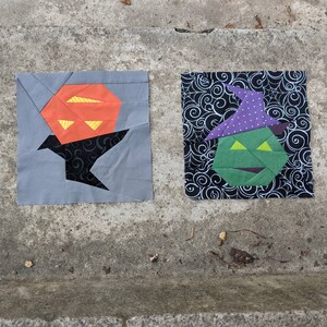 May include: Two Halloween-themed fabric squares. The first square is gray with a black silhouette of a crow holding a jack-o'-lantern. The second square is black with a white swirl pattern and a green witch's face with a purple hat.