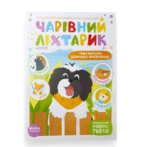 以下が含まれることがあります： 黄色いバンダナをした白黒の犬が描かれたカラフルな雑誌の表紙。雑誌のタイトルは「チャーミングランタン」で、ウクライナの子供向けのペットに関する雑誌です。表紙には、猫、犬、鳥のイラストも描かれています。