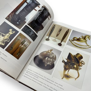May include: A collection of bronze sculptures, including a rocking horse, a whimsical figure with a top hat, a stylized bird, and a vase. The sculptures are displayed on a white background.