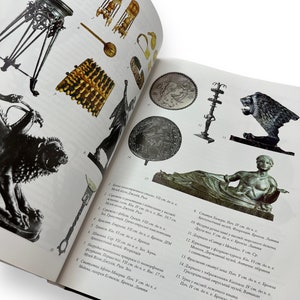 May include: A collection of ancient artifacts, including jewelry, a tripod, a bronze lion, and a statue of a reclining figure. The artifacts are displayed on a white background.