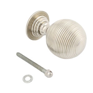 May include: A silver cabinet knob with a spherical, ribbed design. The knob is shown with a screw and washer. The hardware is suitable for furniture and home decor projects. The knob's diameter is approximately 4 cm.