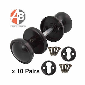 May include: Ten pairs of dark brown door knobs, keyhole covers, and screws are displayed. The knobs are oval-shaped. The text "x 10 Pairs" is visible. These are suitable for interior doors.