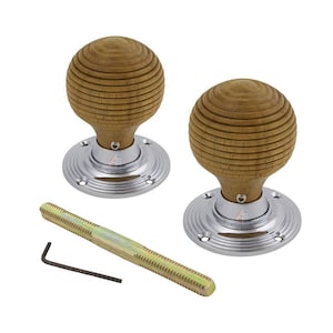 May include: Two wooden door knobs with a ribbed, spherical design. The knobs are mounted on polished chrome bases. A long, threaded bolt and an Allen key are also included, suggesting a hardware or home improvement product.