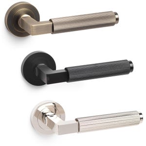 May include: Three door handles in bronze, black, and silver. Each handle features a round base, a square connecting piece, and a ribbed, cylindrical handle. The bronze handle has a warm, antique brass finish, the black handle is matte, and the silver handle is polished.