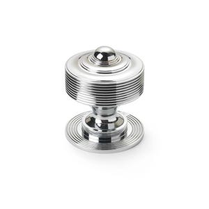 May include: A shiny chrome cabinet knob with a circular, ridged design. The knob has a small, spherical top and a circular base. The symmetrical design reflects light, giving a bright, metallic look. Suitable for drawers and cabinets. The knob is made of metal.