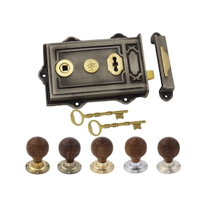 May include: A set of antique door hardware featuring a cast iron lock with brass details, two keys, and five wooden doorknobs with metal bases. The lock is rectangular with decorative elements.