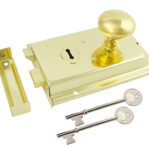 May include: A polished brass door lock set, featuring a round knob, keyhole, and two keys. The set includes a rectangular lock body and a separate strike plate. The finish is a bright, shiny gold colour.