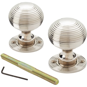 May include: Two polished nickel door knobs with a spiral design. The knobs are round and sit on a circular base. A long threaded rod and an Allen key are also included.