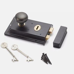 May include: A black door latch with a round knob, keyhole, and two brass-coloured latches. Two silver keys and a small pile of black screws are also included. The latch is a classic design.