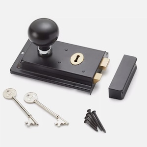 May include: A black door latch with a round knob, keyhole, and two keys. The latch has a rectangular shape with brass-coloured accents and comes with a matching strike plate and screws. A classic hardware item.