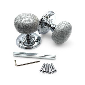 May include: A pair of ceramic door knobs with a grey and white crackle glaze design, set on polished chrome bases. The image also shows a metal bar, an Allen key, and several screws, all on a white backdrop.