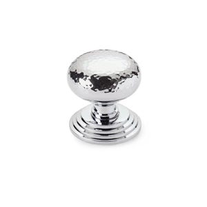 May include: A polished chrome cabinet knob with a hammered texture on the spherical handle. The base features concentric rings. Suitable for drawers and cabinets. The knob is approximately 4 cm in diameter.