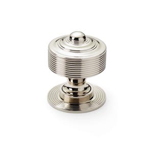 May include: A polished nickel cabinet knob. The knob has a cylindrical body with a rounded top and horizontal grooved detailing. It sits on a circular base. This hardware is designed for furniture and cabinetry.